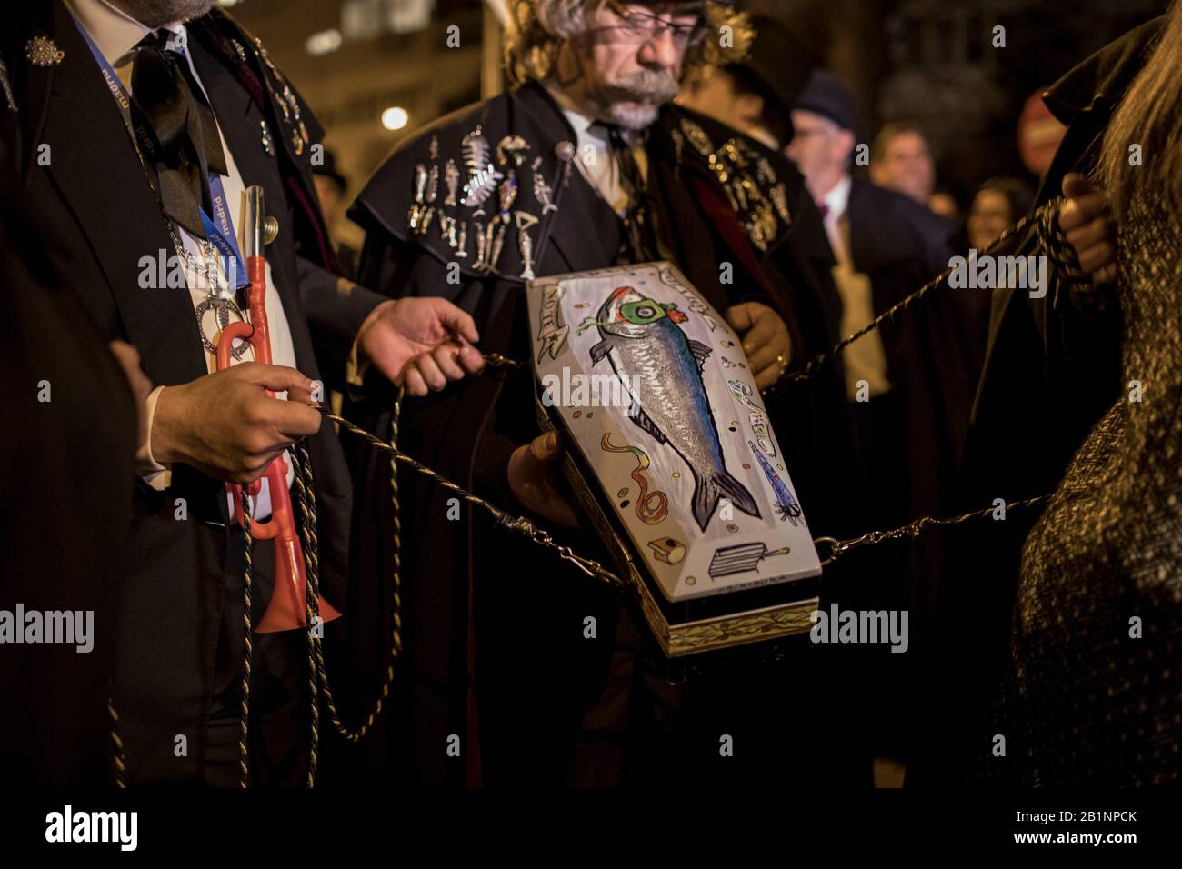 Coffin of the Sardine carried by the members of the brotherhood of the sardine during the procession. The Sardine procession which takes place in Madrid, is a centuries-old Spanish tradition made famous by a painting of the Spanish artist Francisco de Goya called ‘The Burial of the Sardine'. It mark the end of Carnival celebrations and the beginning of Lent 40 days before Easter. It consists of a procession that parodies a funeral in which a symbolic figure of a sardine in its coffin is burned. The festivity takes place every Ash Wednesday and symbolizes the burial of the past and the rebirt Stock Photo