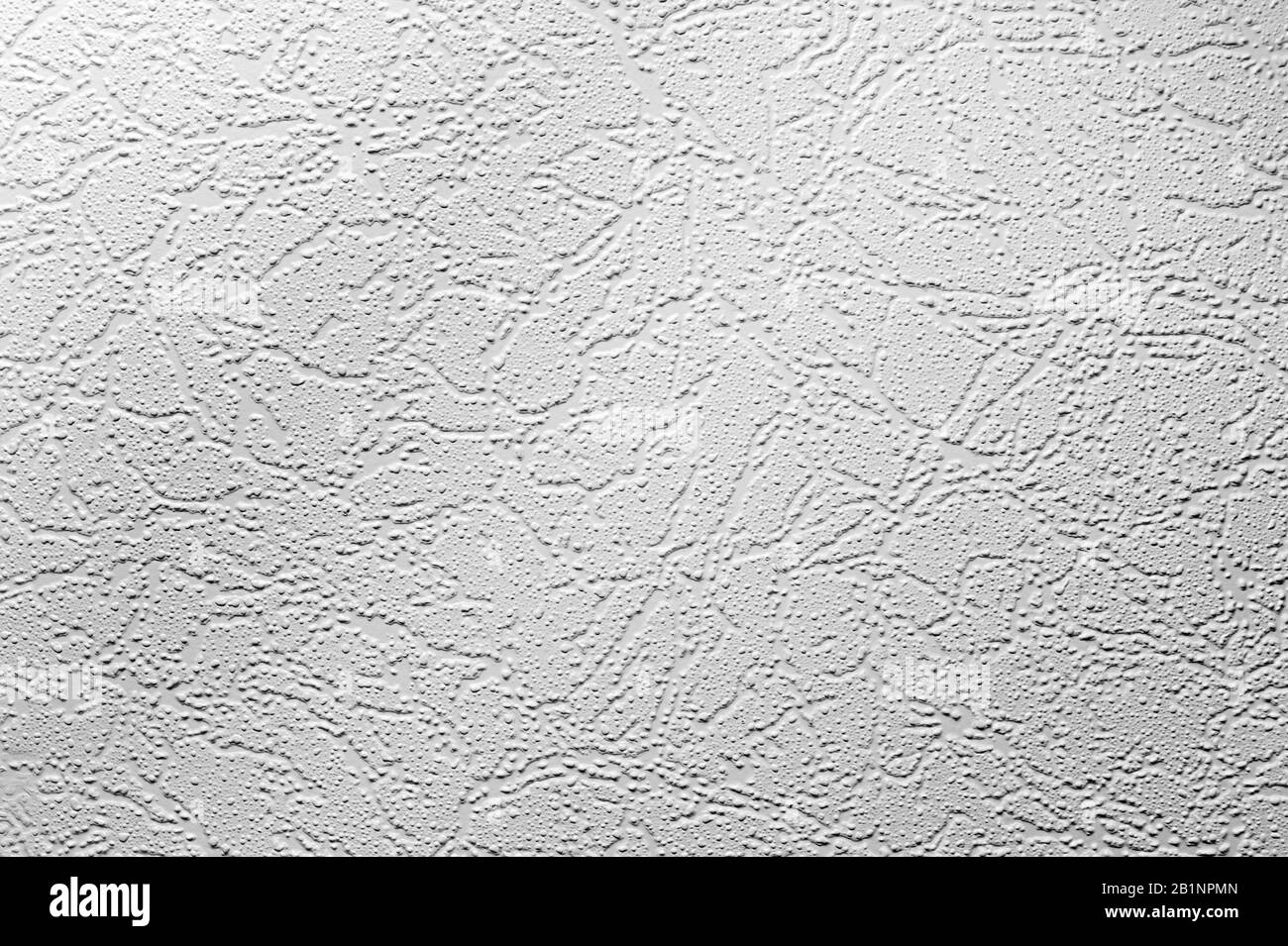 white texture of the wall with putty, cracks and small holes made by