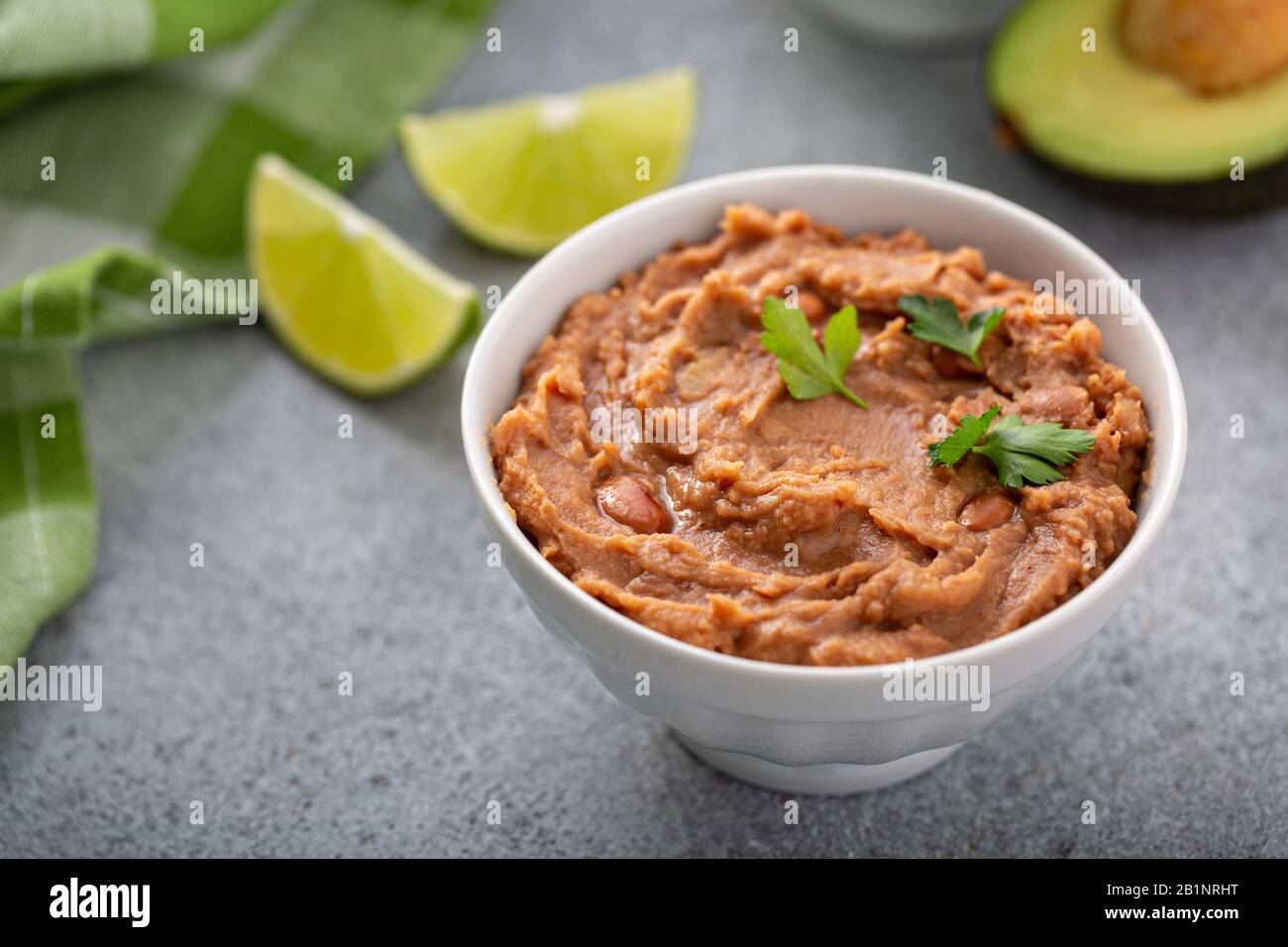 Refried beans in a white bowl Stock Photo Alamy
