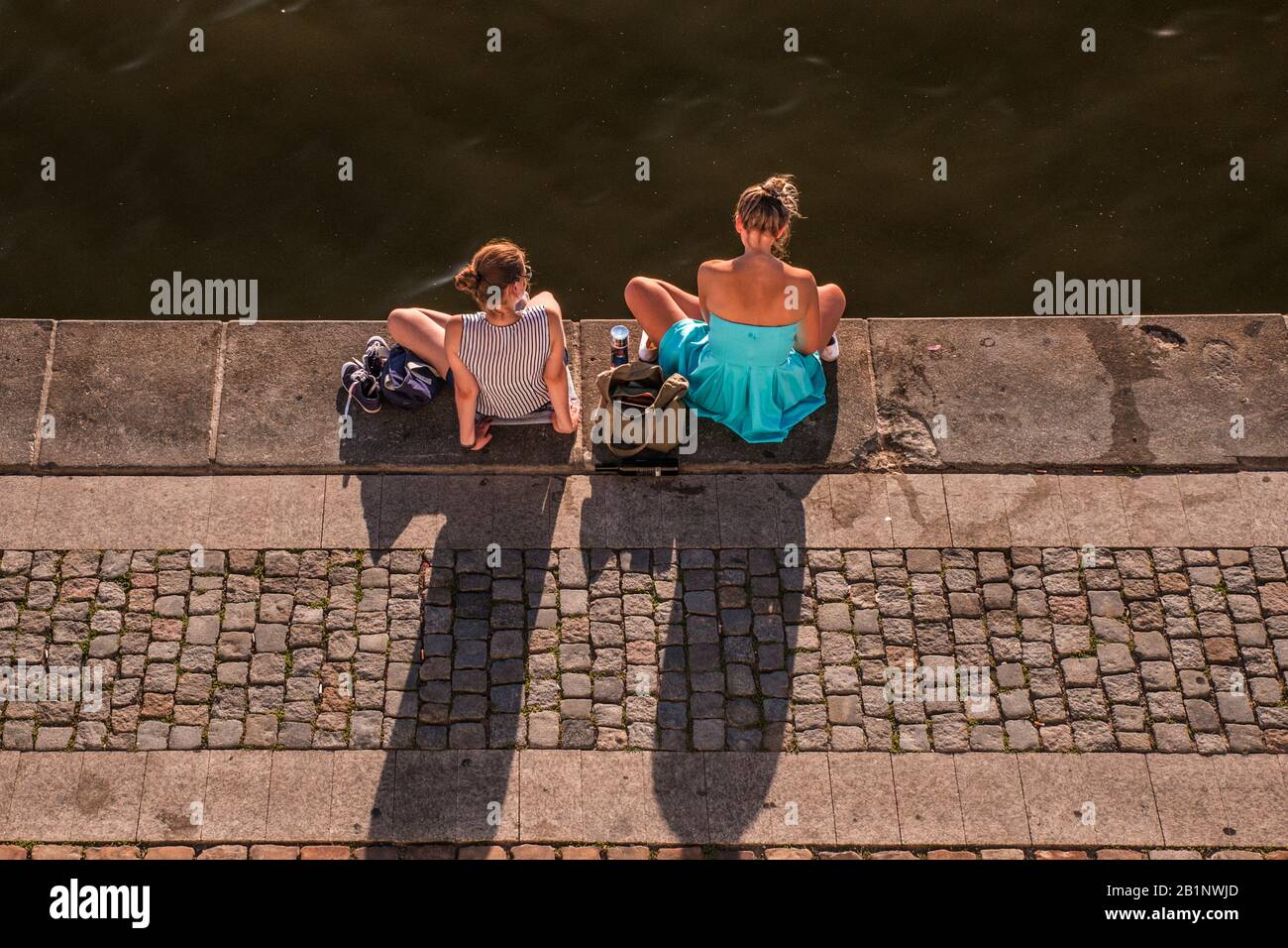 Two girls speaking a banks of Vltava river, Prague, Czech Republic Stock Photo