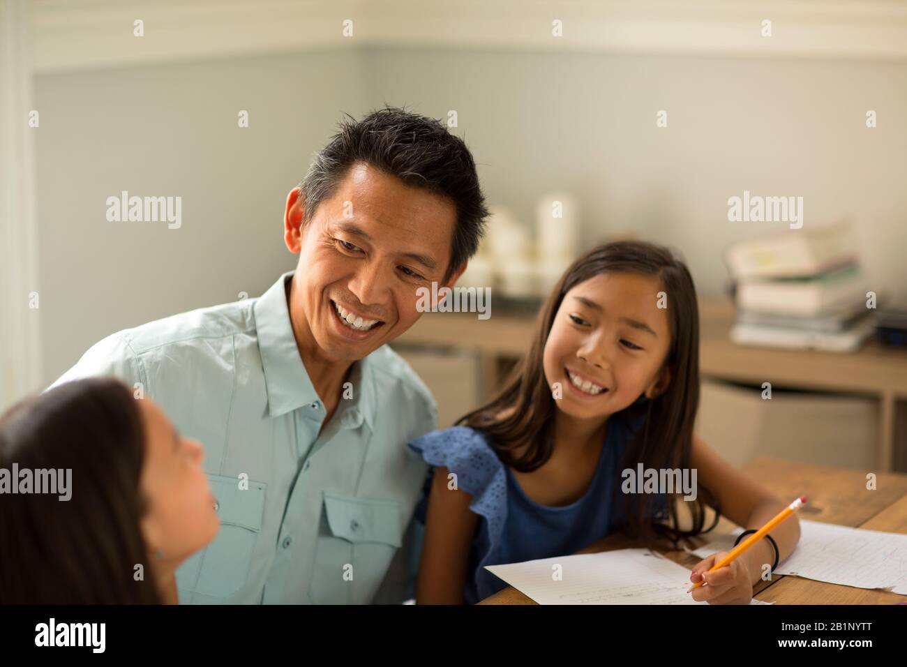 Mother Helping Her Daughters With Their Homework Stock Photo - Alamy