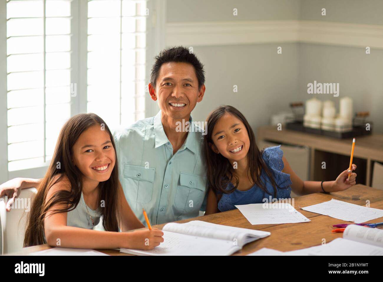 Mother Helping Her Daughters With Their Homework Stock Photo - Alamy