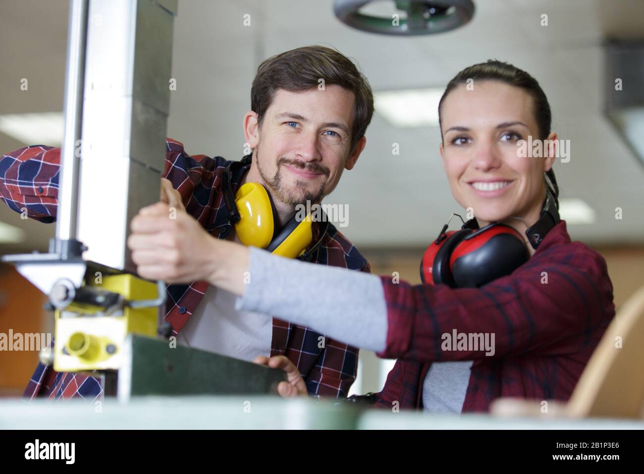 engineer training female apprentice on milling machine Stock Photo
