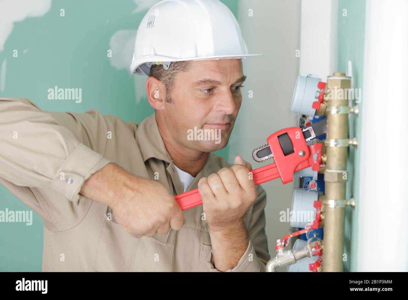 plumber at work installing a water meter Stock Photo Alamy