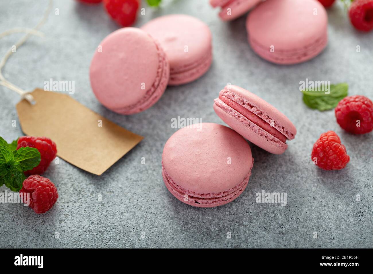 Raspberry macarons on gray table Stock Photo
