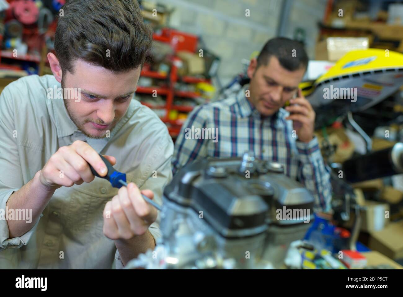 mechanic helping trainee to fix engine Stock Photo Alamy