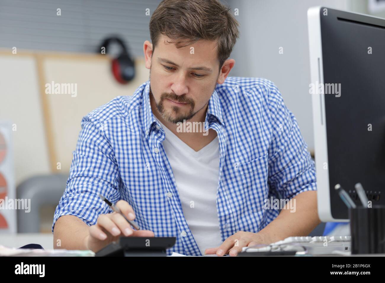 man doing accounts in the office Stock Photo