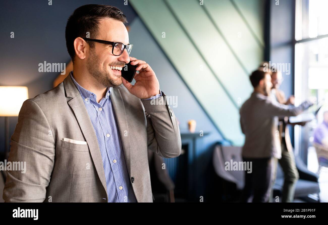 Young handsome businessman using smartphone in the office Stock Photo
