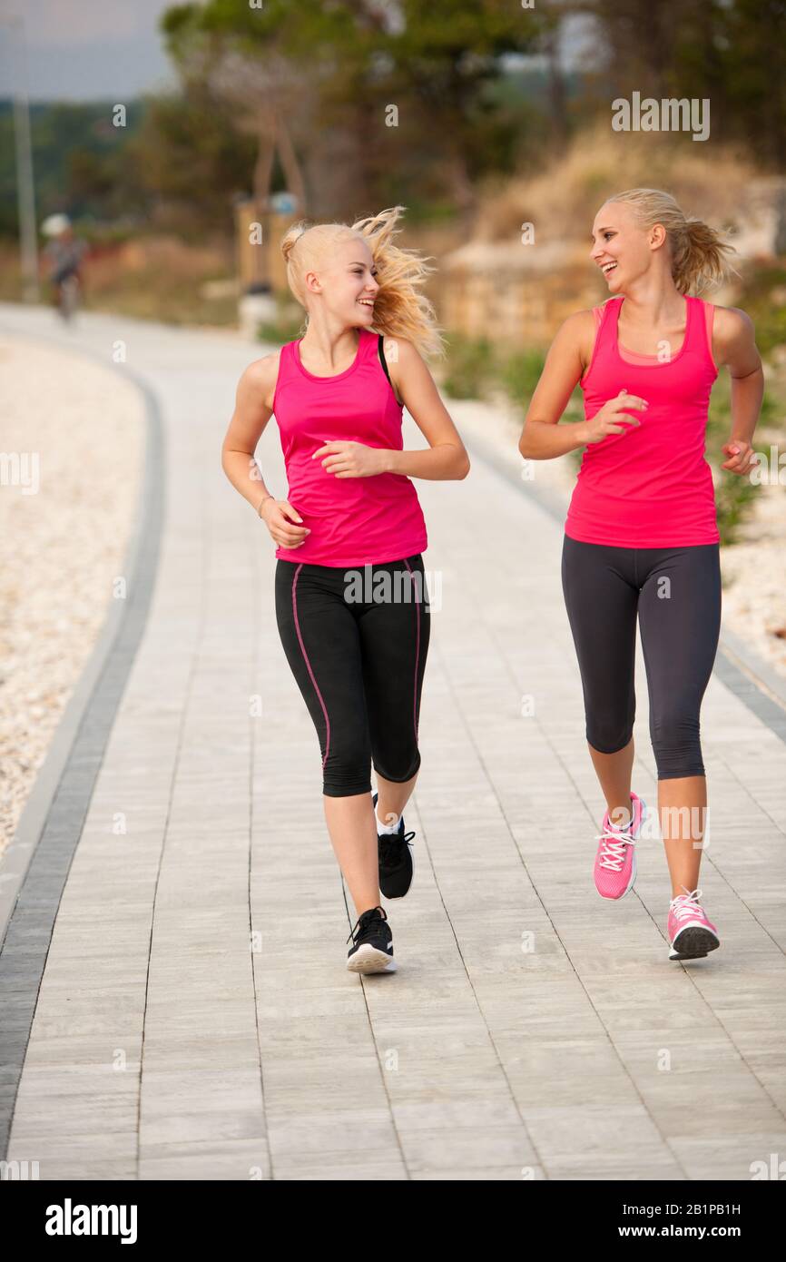 Two Women Running On The Beach Early Morning Summer Workout Stock 