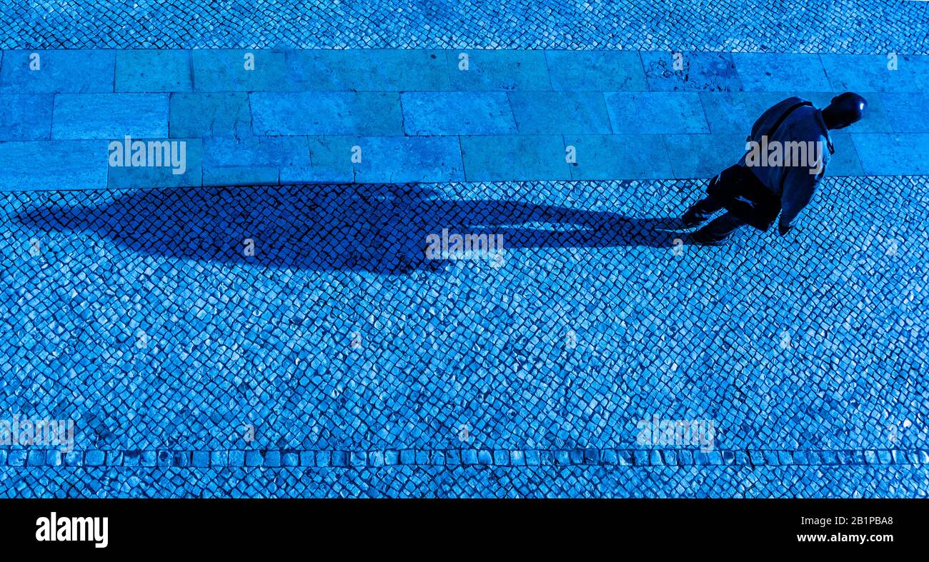 Lisbon, man with long shadow Stock Photo