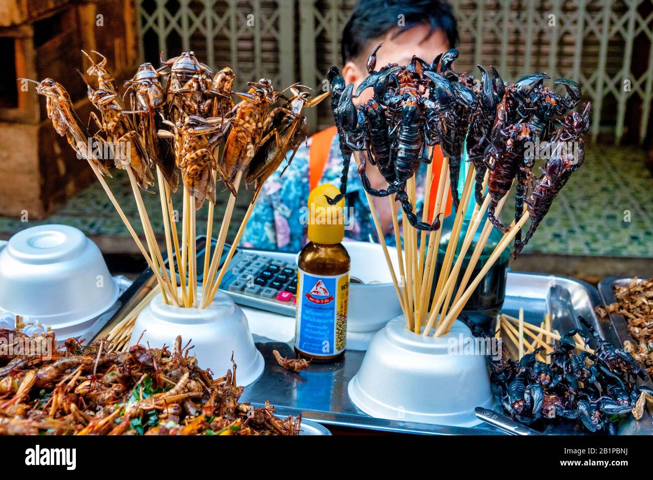 Woman selling insects in the Talat Kao Old Market in Soi 6 of Yaowarat Road, Bangkok, Thailand Stock Photo