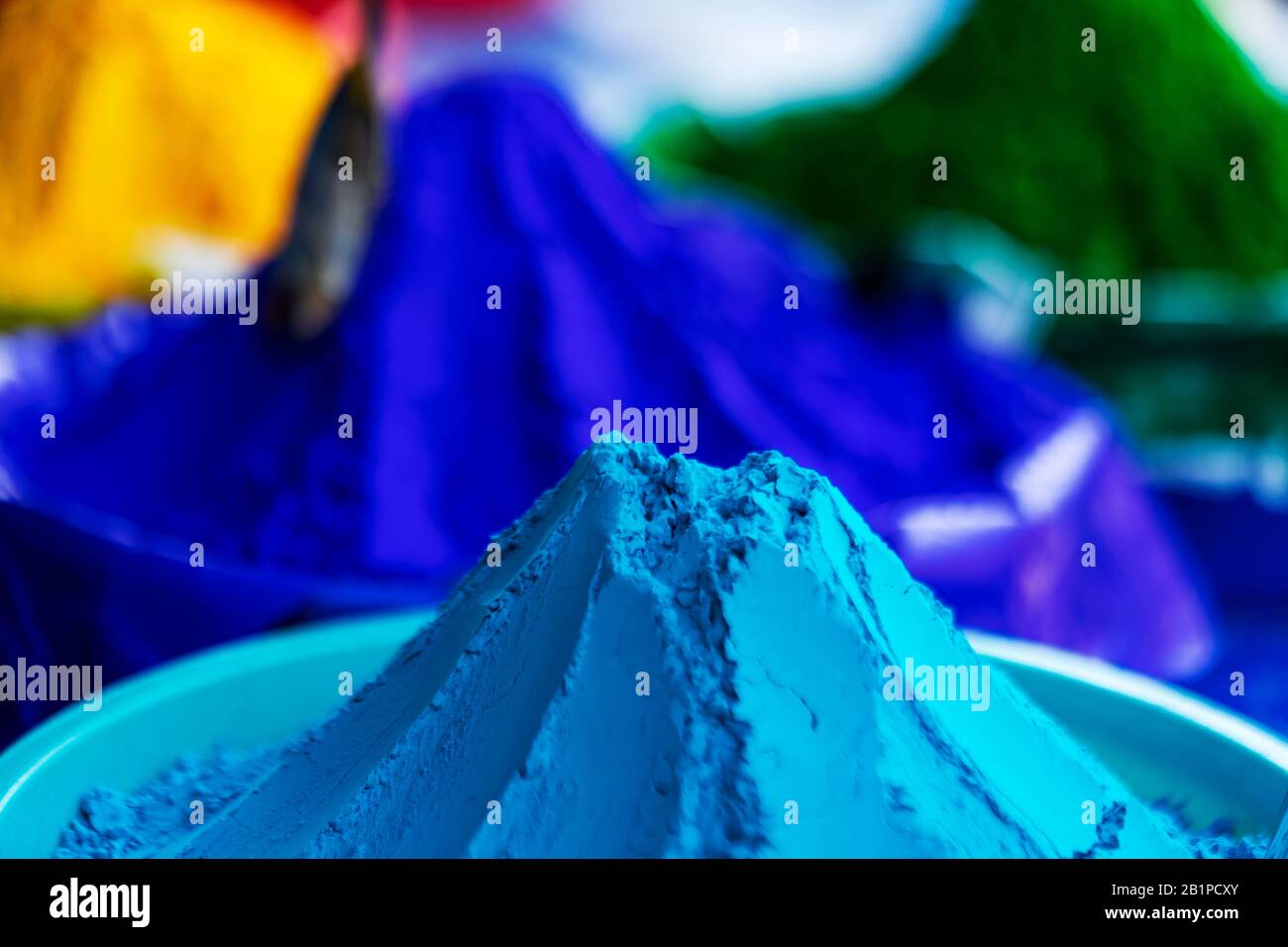 Happy holi Background. Blue organic gulal colors in bowls arranged one by one in local market. Concept for Indian Festival, colorful wallpaper, gift c Stock Photo