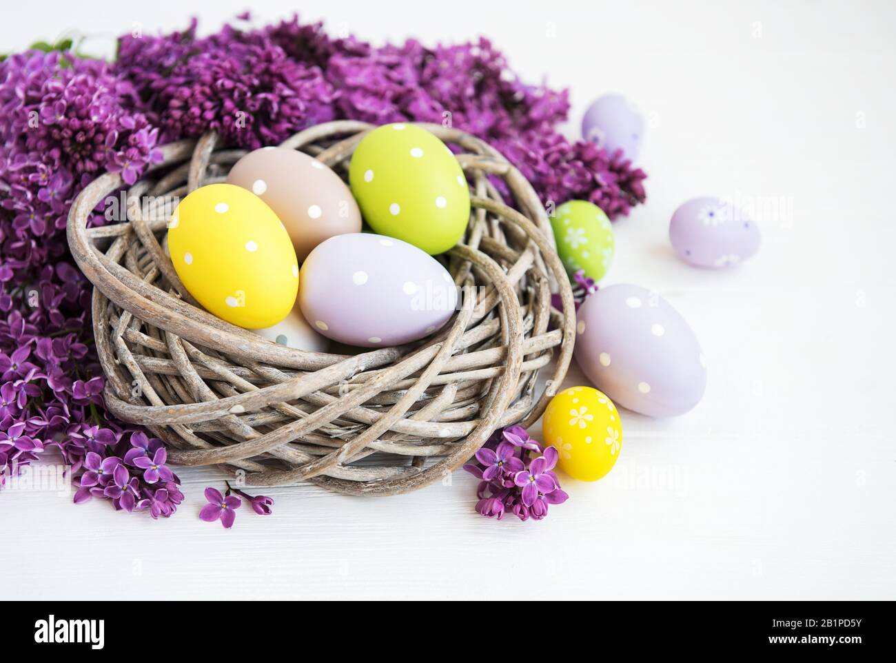Nest with easter eggs and spring lilac flowers Stock Photo - Alamy