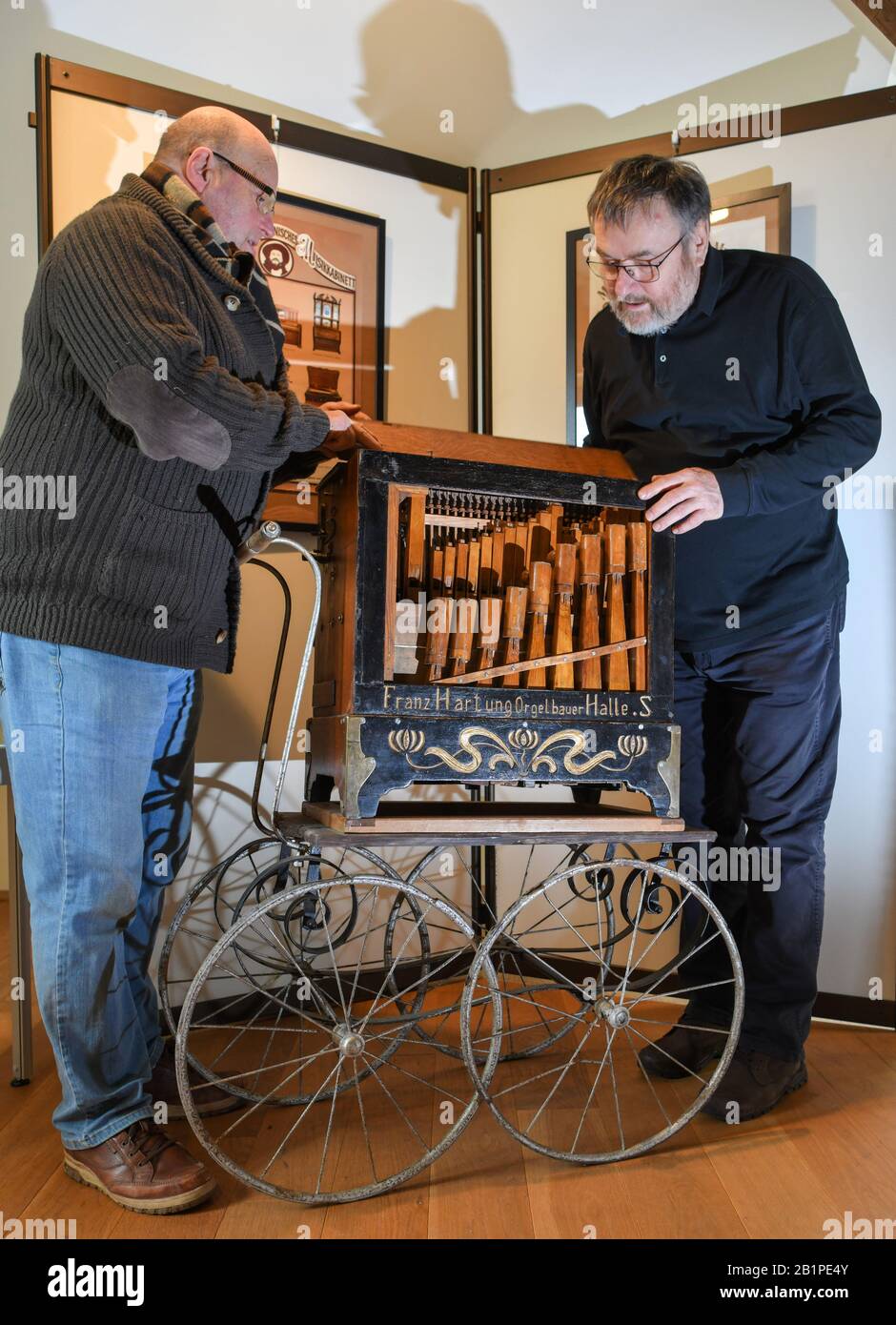 25 February 2020, Brandenburg, Lieberose: Roland Wolf (l), a collector of lyre cases and other mechanical instruments, and Dieter Klaue, chairman of the Lieberose Association, talk about a barrel organ that is more than 100 years old. About two dozen old mechanical musical instruments are shown and played in Lieberose (Dahme-Spreewald). Photo: Patrick Pleul/dpa-Zentralbild/ZB Stock Photo