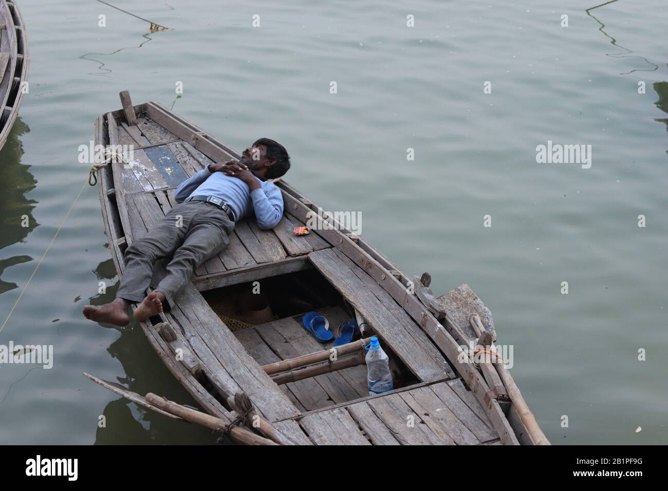 Indian men is sleeping on his boat Stock Photo