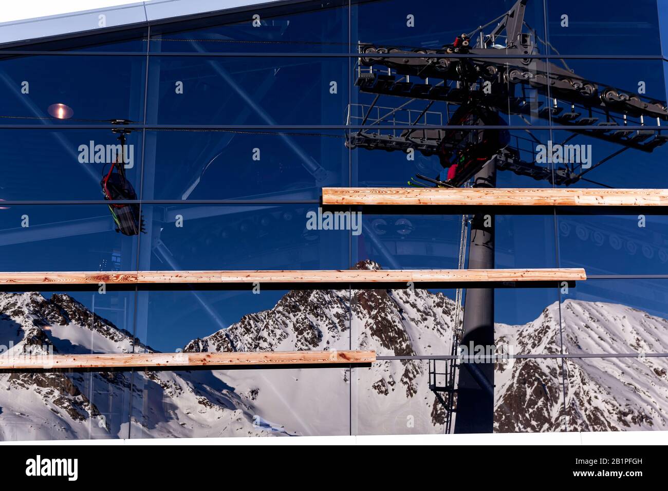Ischgl, Austria - January 2020: reflection of mountains and cable car in the panoramic windows of the Pardorama restaurant in the ski resort of Ischgl Stock Photo