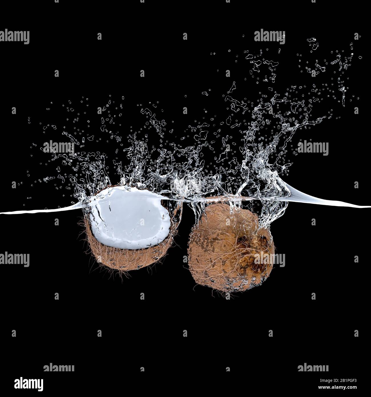 3d render of coconut fruit falling into water and creating big splashes. black background nobody around. concept of freshness and diet, tropical food. Stock Photo