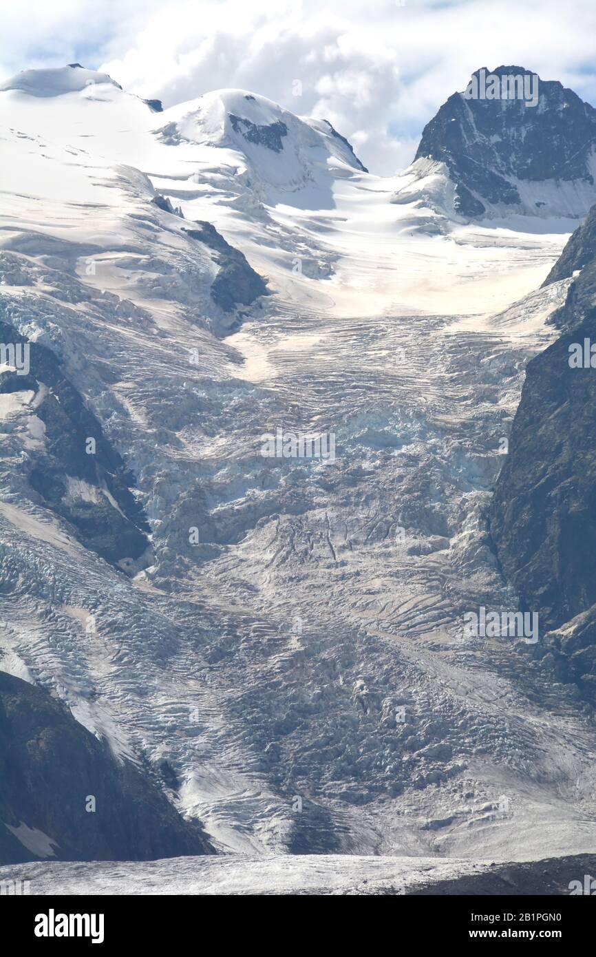 Piz Argient (left) and the Crast Aguzza and their ice fall viewed from the Bernina Pass in southern Switzerland above St Moritz. Stock Photo