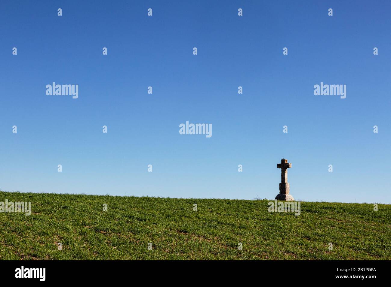 Stone cross on the crest of a hill in Andalusia, Spain Stock Photo