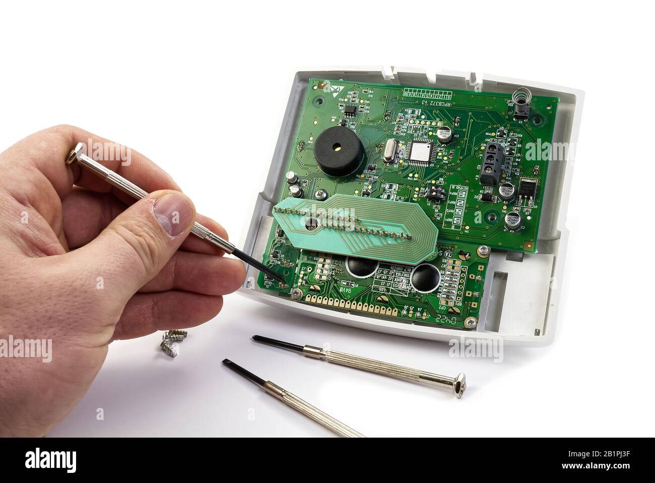 Home alarm control panel repairing. Open Electronic board panel with