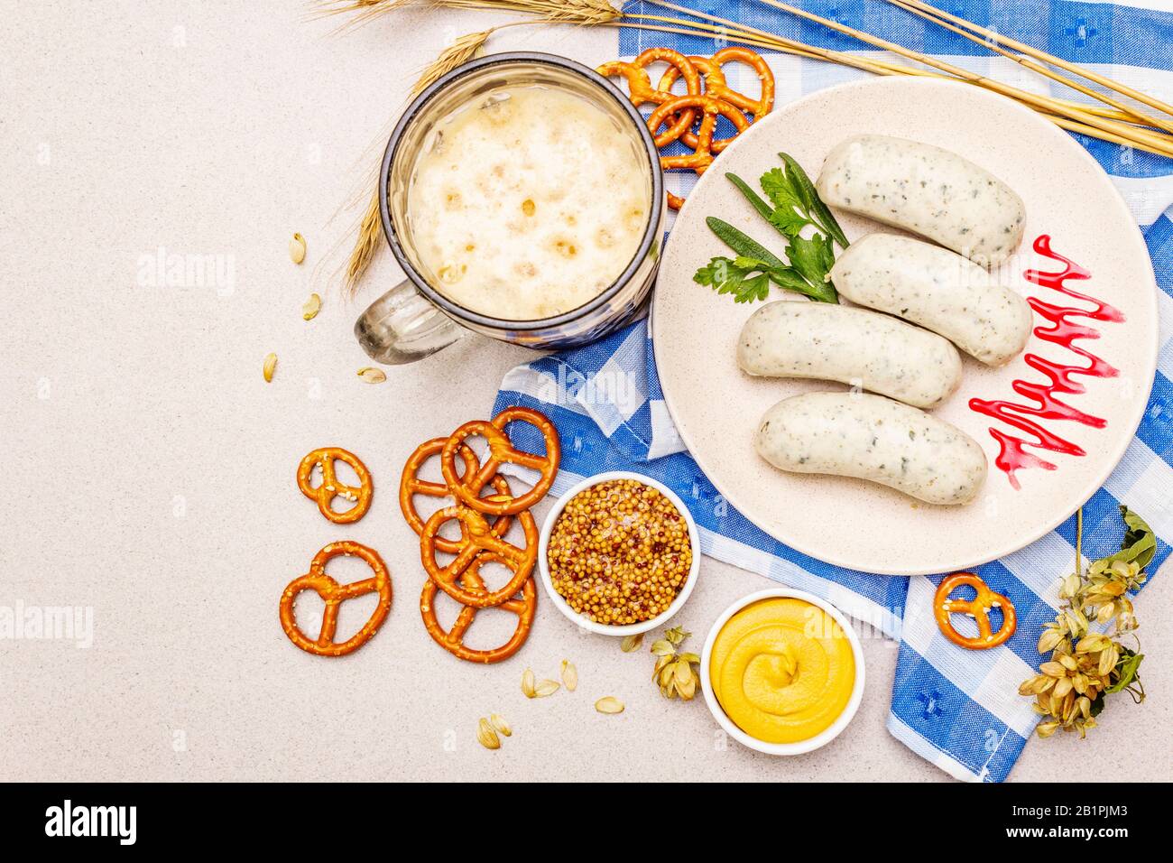 Oktoberfest set. Dark beer, weisswurst, pretzels, mustard, spikelets of