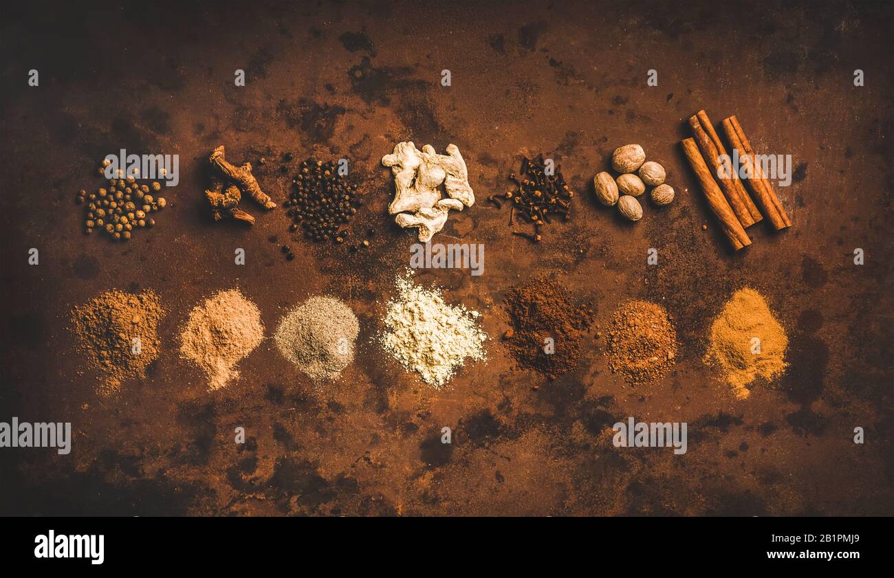 Turkish seven spice Yedi Bahar mix over rusty background Stock Photo