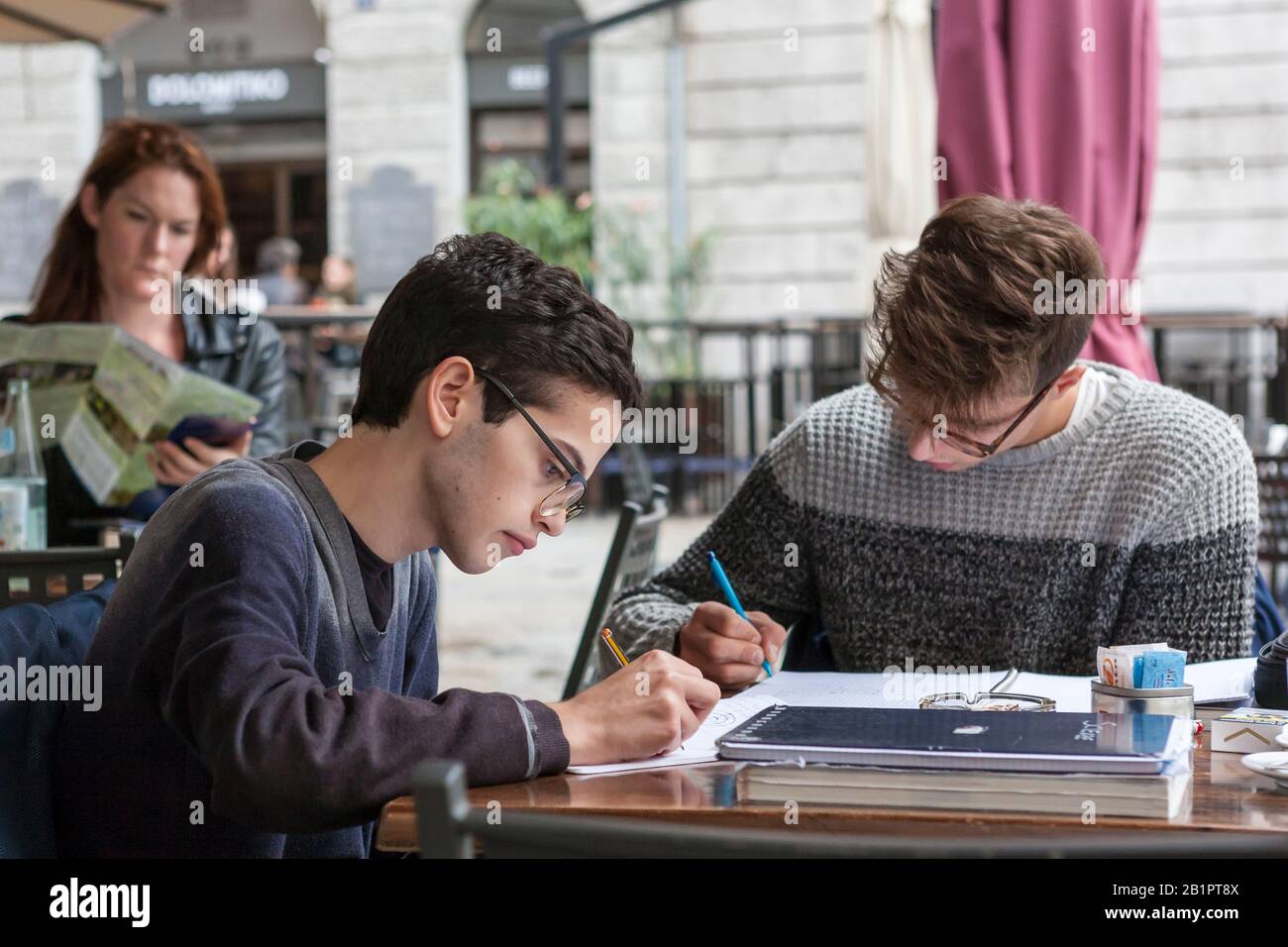 Homework in a café: students studying conscientiously,Trattoria 'Alla Motonave', Via Torino 33, Trieste, Friuli-Venezia Giulia, Italy Stock Photo