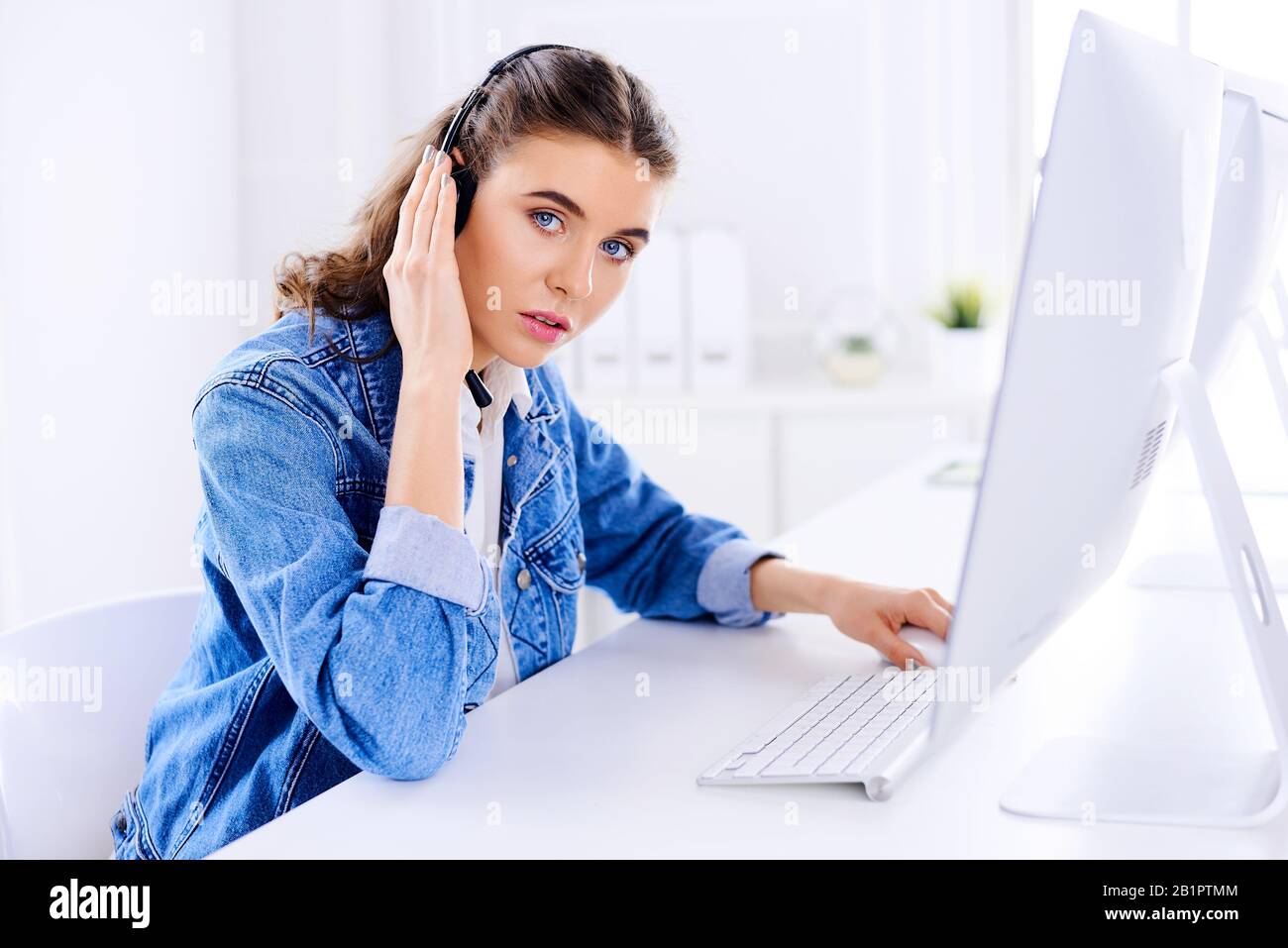 Female technical support agent in office working on computer Stock ...