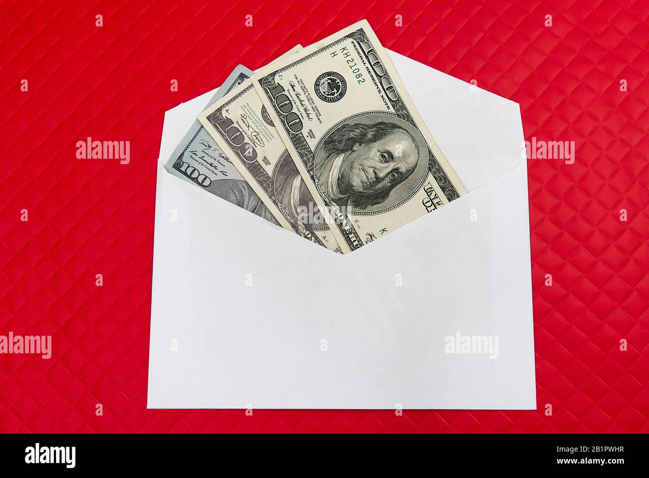 Fan US dollars in cash in red envelope on red background. Money