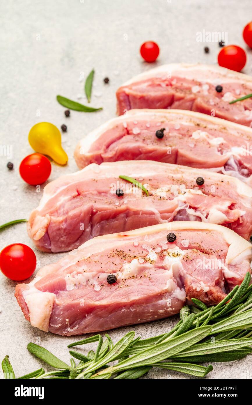 Raw pork belly with rind, peritoneum meat. Fresh tomato cherry