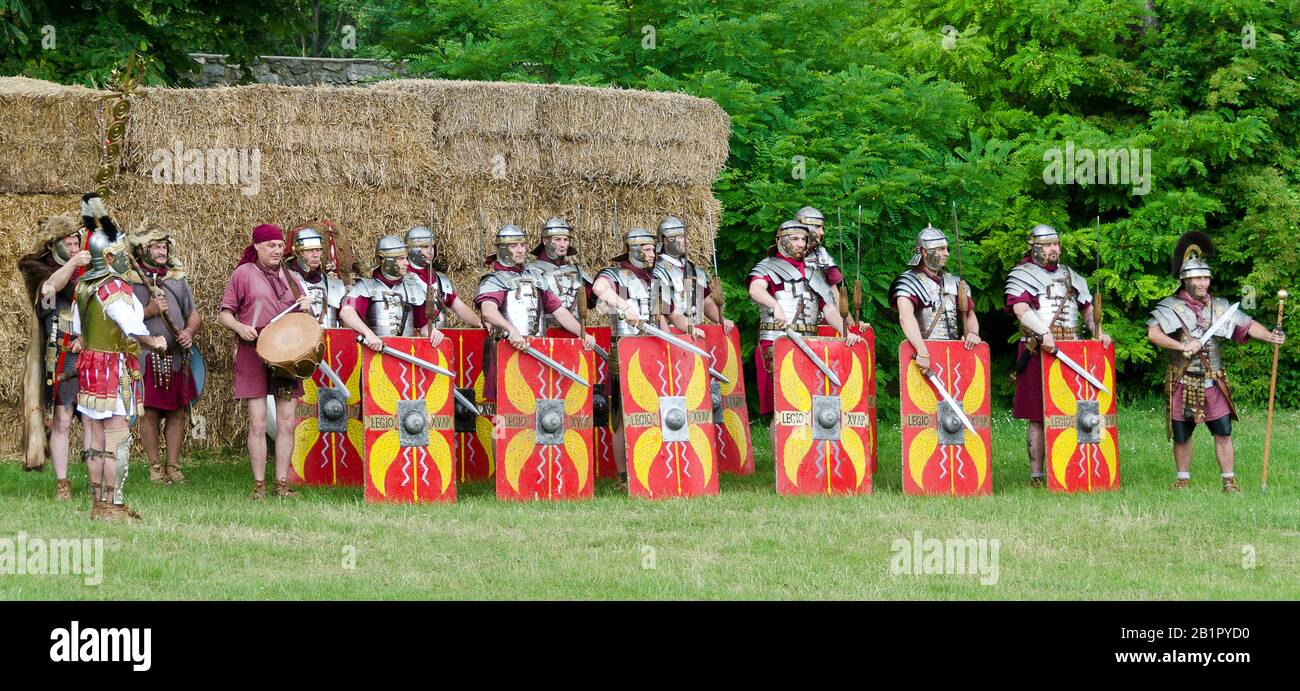 Reenactors representing legionaries from the Legio XV Apollinaris Hungary  beating on their shields at the Roman festival of Carnuntum, Austria Stock Photo