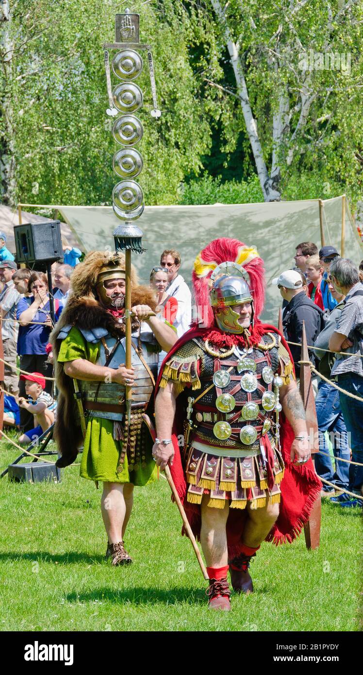 Reenactors representing the commander of the roman camp and a signifer bearing a standard with awards at the Roman festival of Carnuntum, Austria Stock Photo