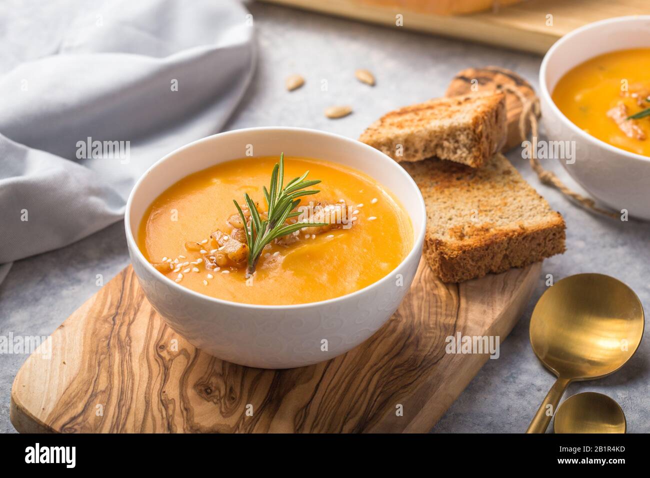 Homemade Autumn Butternut Squash pumpkin cream Soup with Bread and seeds. top view Stock Photo