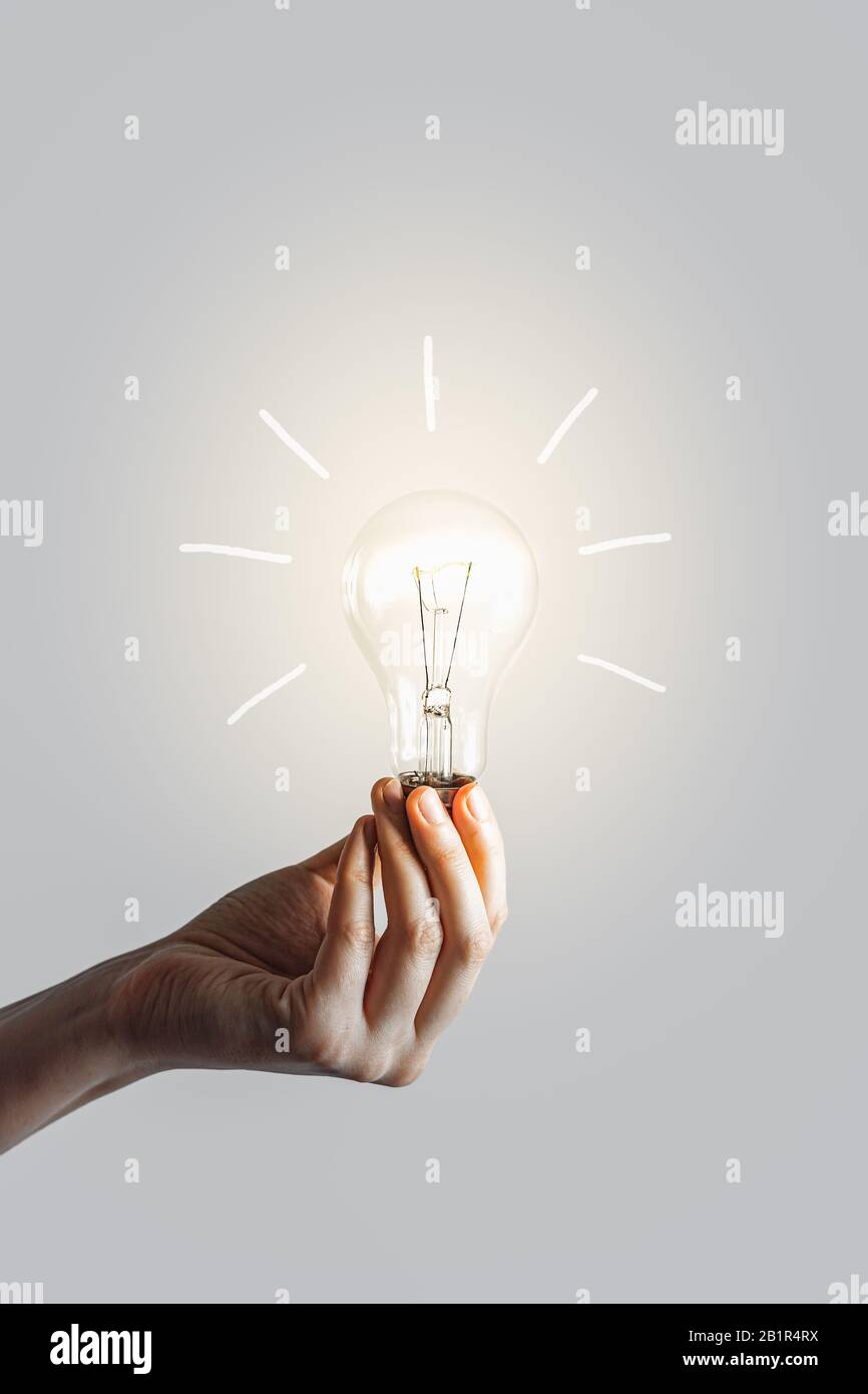 Glowing lightbulb in human hand. Concept of inspiration muse and new ideas creation Stock Photo