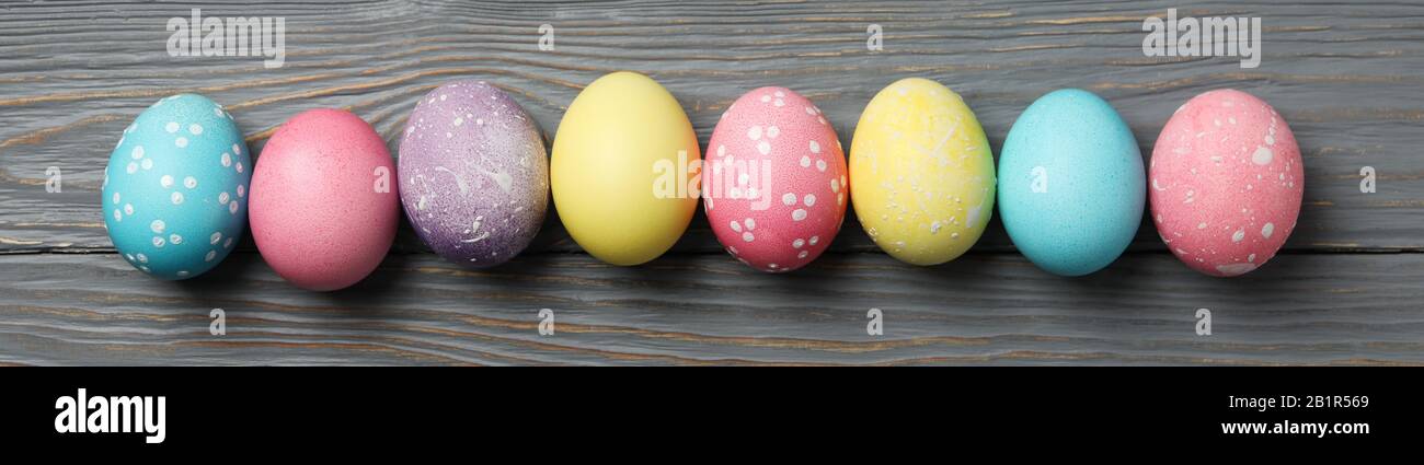 Multicolor Easter eggs on wooden grey background, space for text Stock Photo