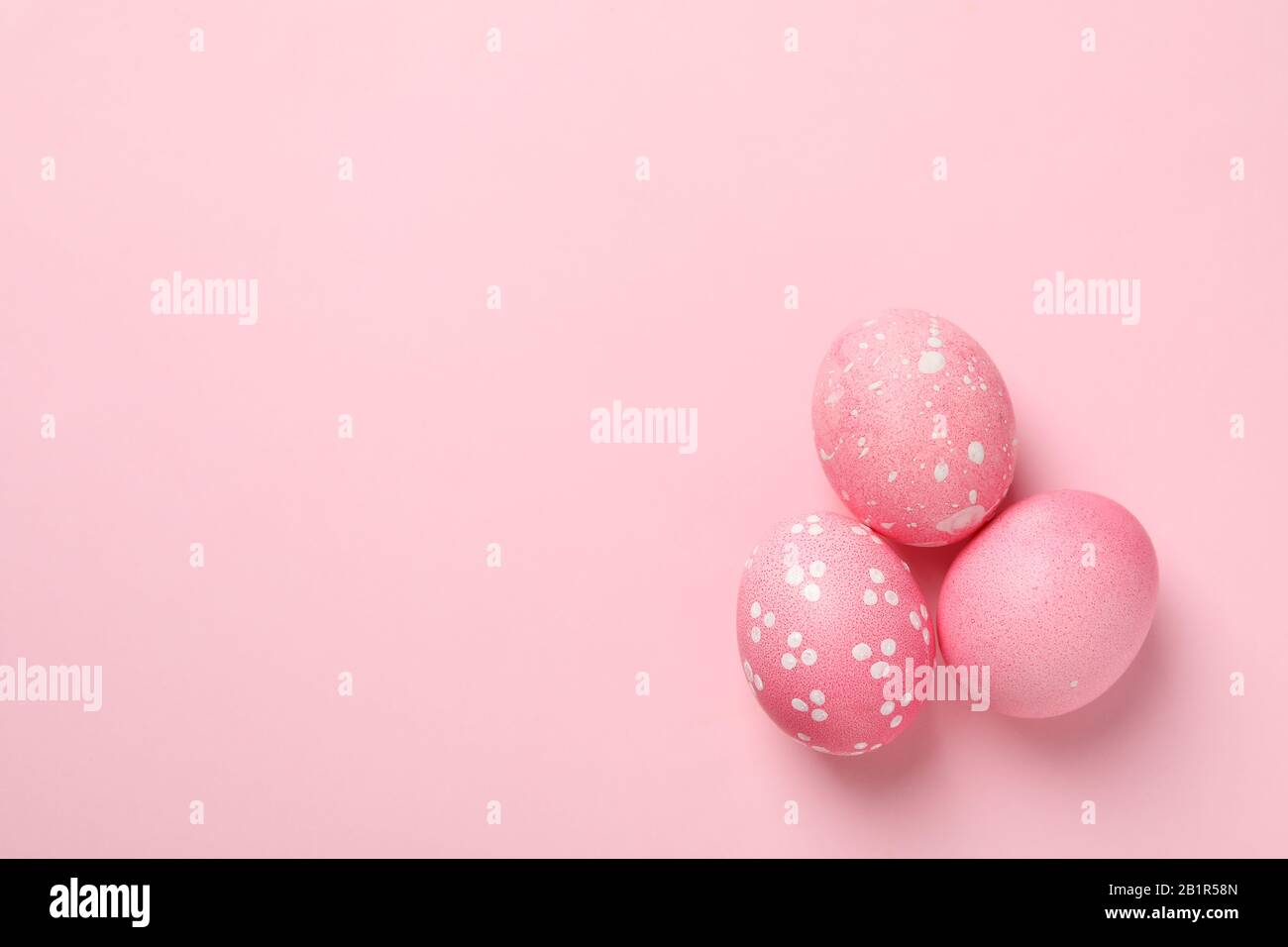 Easter eggs on pink background, space for text Stock Photo