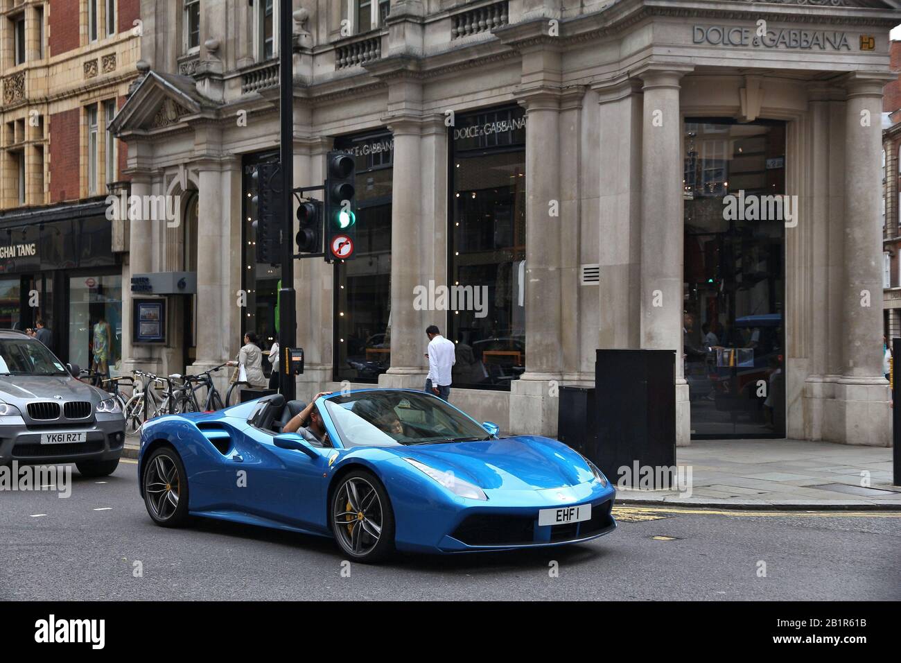 LONDON, UK - JULY 9, 2016: Man drives a Ferrari at Sloane Street in London. Sloane Street is located in Royal Borough of Kensington and Chelsea and is Stock Photo