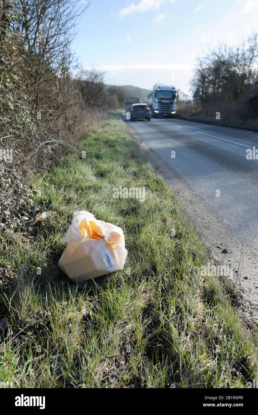 Fast-food packaging discarded at the roadside on a rural road in Wales Stock Photo