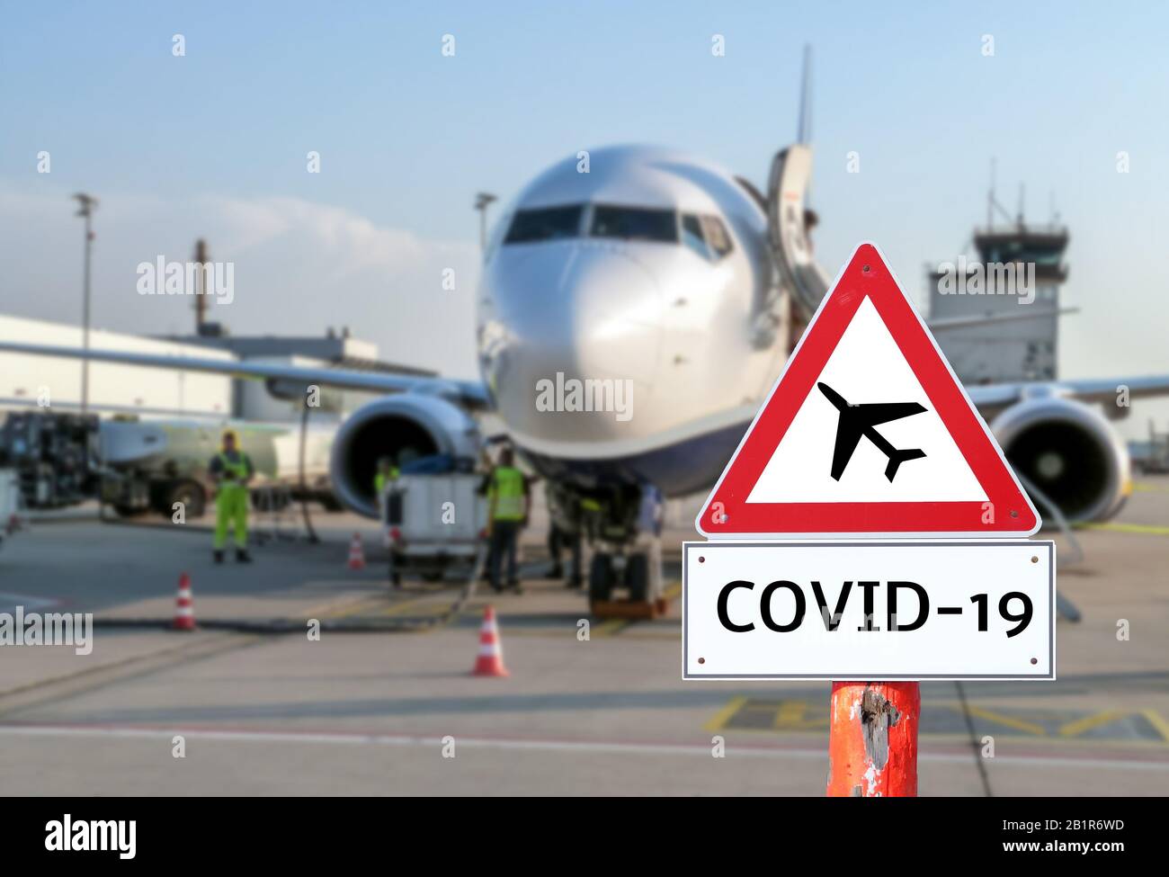Airplane at the airport warning sign coronavirus Stock Photo