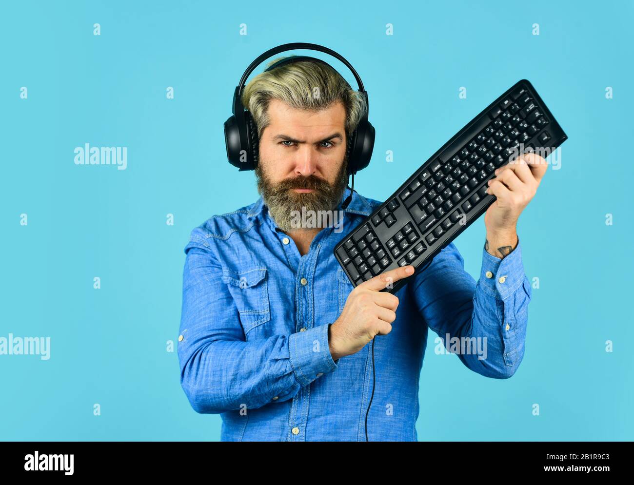 Gaming PC build guide. Graphics settings pushed to limit. Gaming addiction.  Online gaming. Modern leisure. Play computer games. Man bearded hipster  gamer headphones and keyboard. Run any modern game Stock Photo -