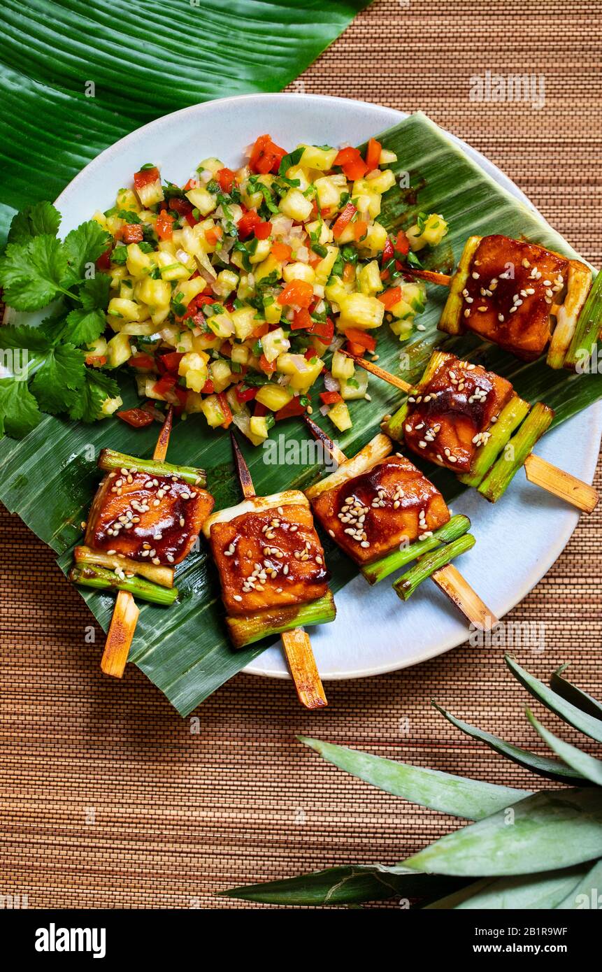 Salmon and spring onion skewers with soy and wasabi glaze Stock Photo