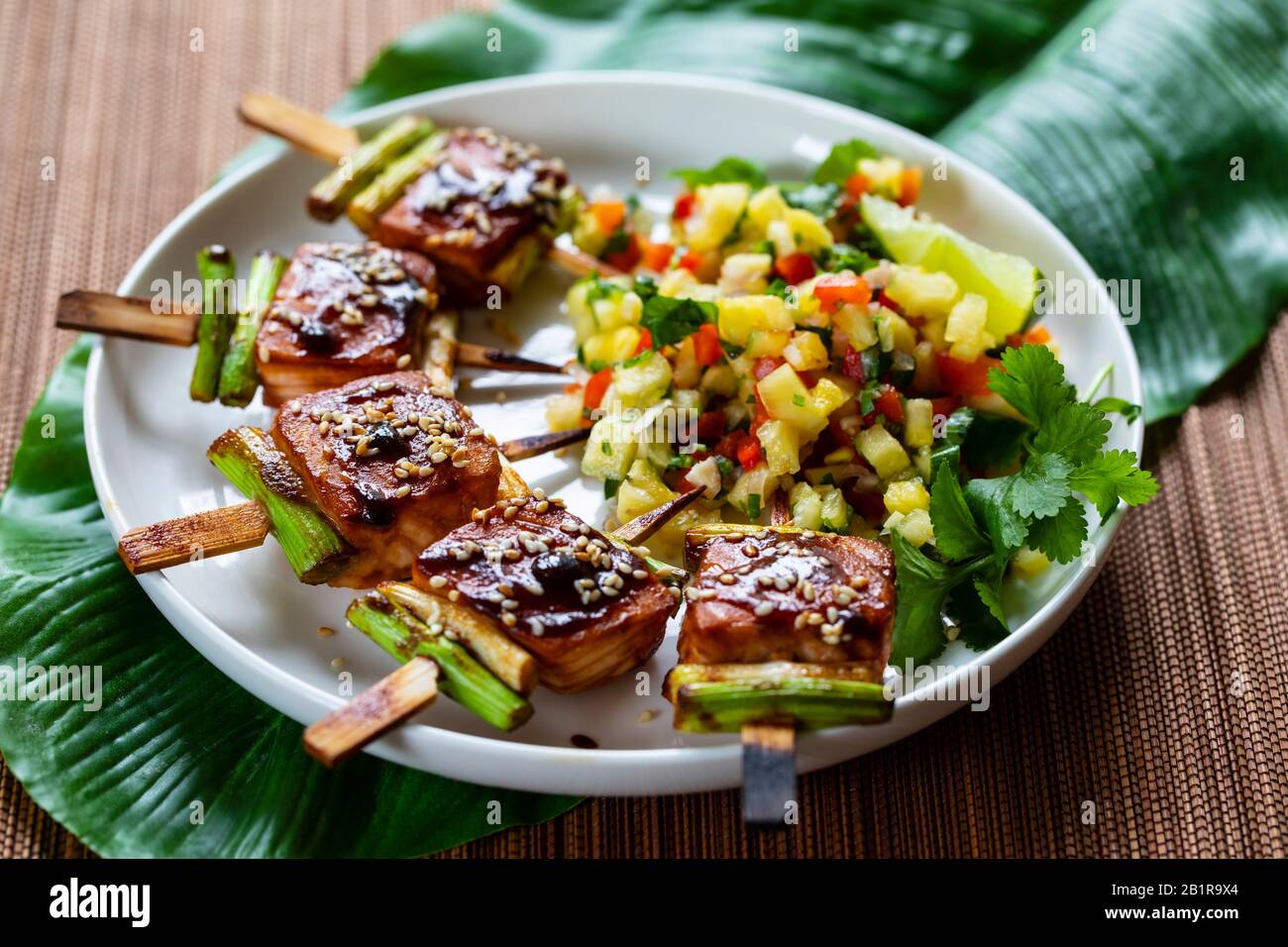 Salmon and spring onion skewers with soy and wasabi glaze Stock Photo