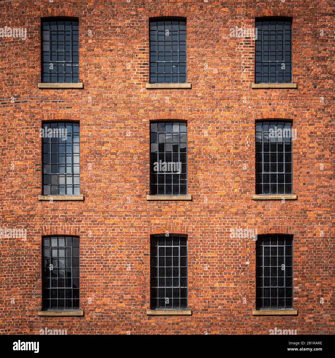 Details of the windows and brickwork in the old warehouse buildings at the Albert Docks in Liverpool Stock Photo