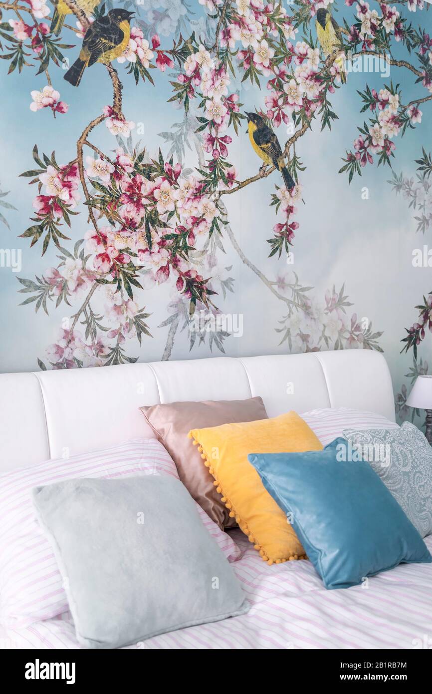 Budapest Hungary June 10 2019 Detail Shot Of Bedroom With Modern Stylish Spring Birds Theme Wallpaper Colorful Pillows And White Headboard Stock Photo Alamy
