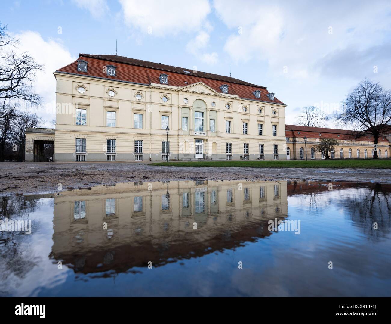 27 February 2020, Berlin: The theatre building of Charlottenburg Palace is reflected in a puddle. The Käthe Kollwitz Museum will move into the representative theatre building in 2022. Photo: Christophe Gateau/dpa Stock Photo