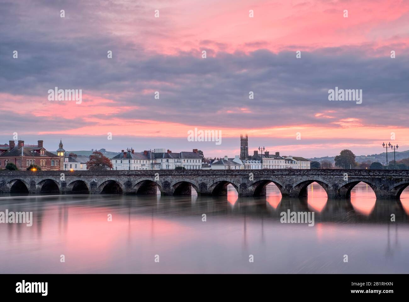 Pink Sunrise skies over the Barnstaple, Medieval Long Bridge, over the river Taw , North Devon, South West, UK Stock Photo