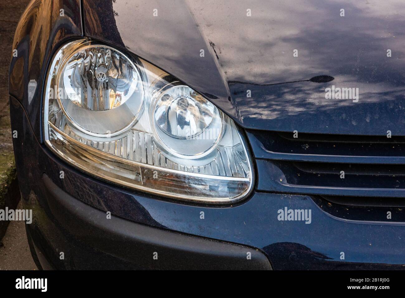 Front view, headlight of Volkswagen Golf V (five). Bucharest, Romania, 2020. Stock Photo