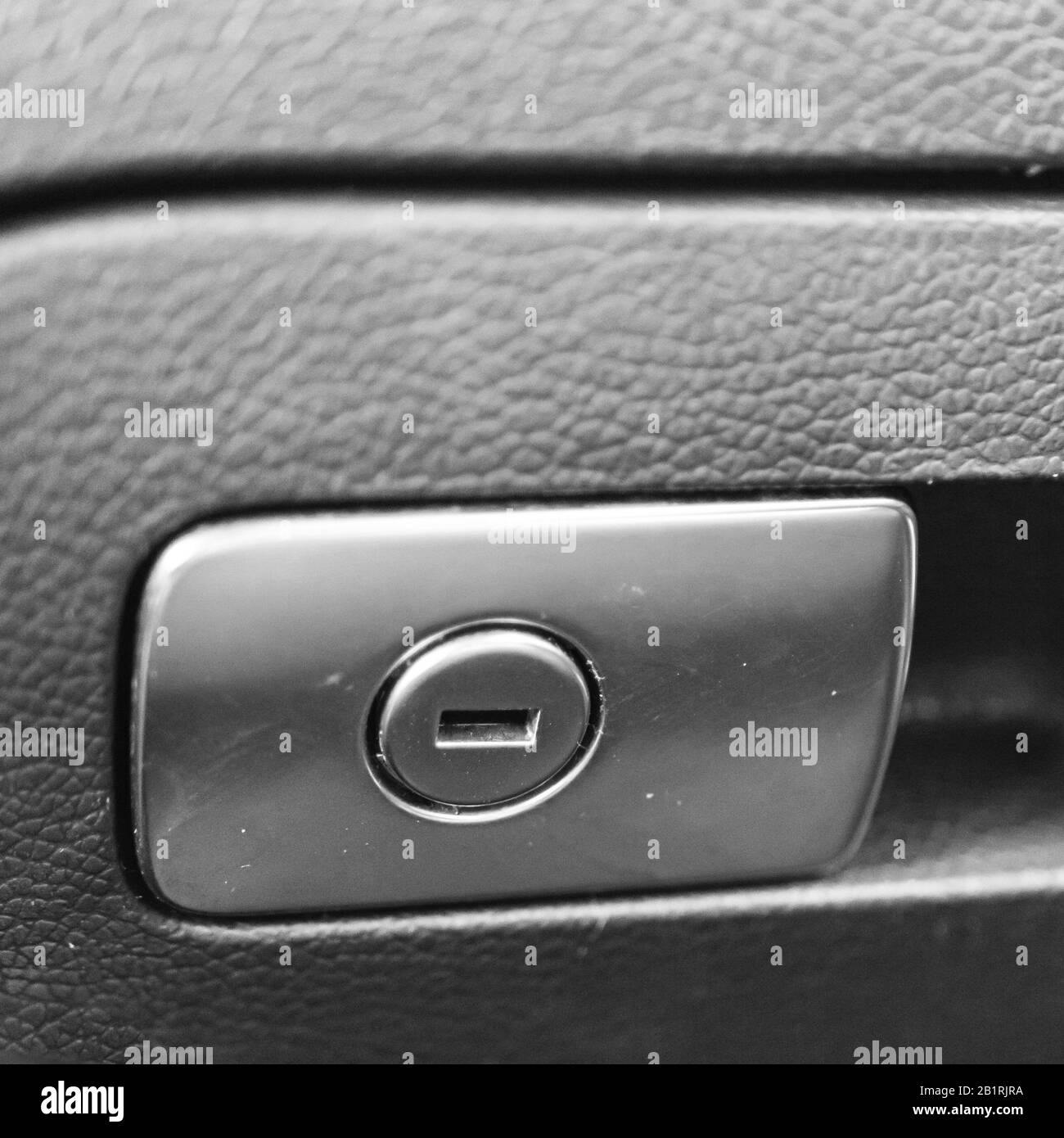Close up photo inside a car, keyhole of closed car glove box. Stock Photo