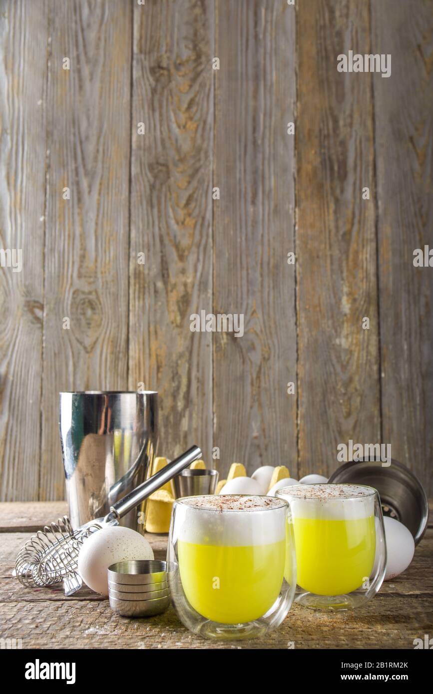 Autumn Homemade Bourbon Egg Flip Cocktail with spices, wooden background with ingredients Stock Photo
