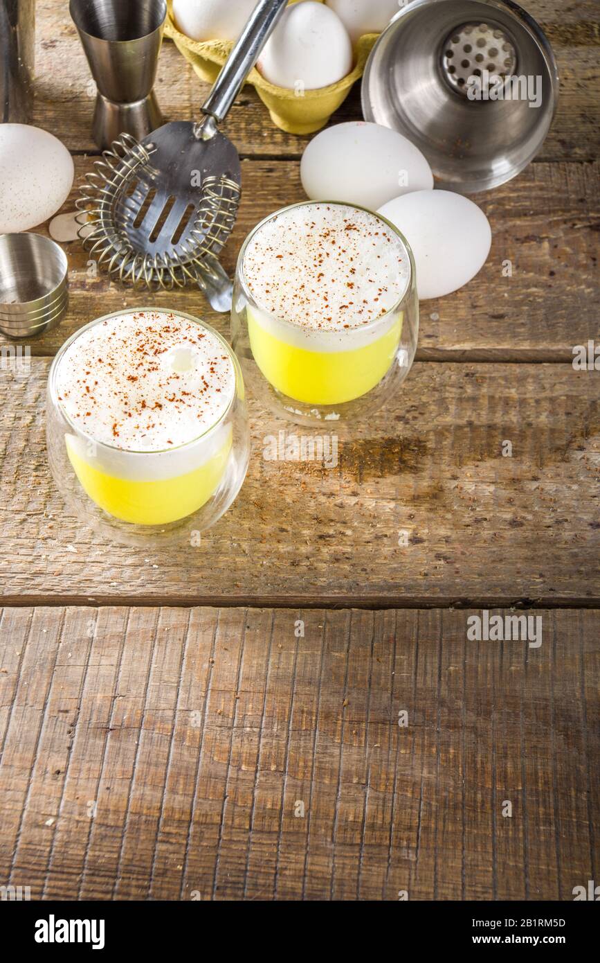 Autumn Homemade Bourbon Egg Flip Cocktail with spices, wooden background with ingredients Stock Photo